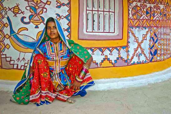 Girl outside a painted Bhunga in Kutch